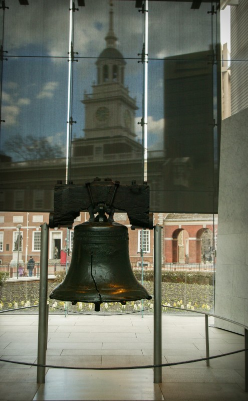 In the recently opened Liberty Bell Center, the symbolic bell is viewed against the backdrop of its original home in the Pennsylvania State House. (Photograph for the Encyclopedia of Greater Philadelphia by Jamie Castagnoli)