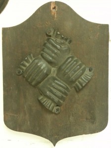 The symbol of the Philadelphia Contributionship consisted of four clasped hands, representing the community helping each other through loss by fire. This image appeared on fire marks placed on insurance holder's buildings, and still represents the company today. (Camden County Historical Society)  