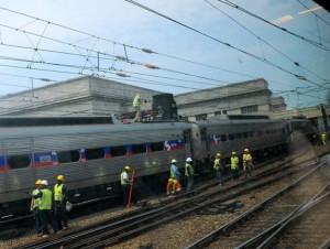 SEPTA employees work on a commuter train that was stuck on the track because of overhead wire problems