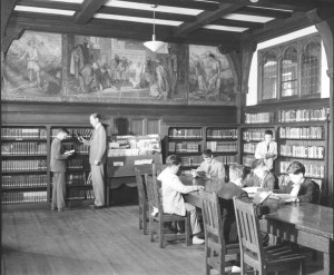 black and white photo of library with students and a teacher at Chestnut Hill Academy, c 1956