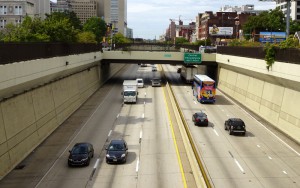 Color photo of traffic moving in both directions on the Vine Street Expressway one afternoon in mid-September 2015.
