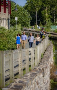 People enjoying a walk on the Manayunk Canal Towpath, now a modern day park.