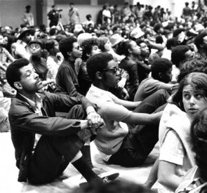 A black and white photograph of a seated crowd at the Black Panther Party convention, Temple University