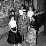 Photograph of Dick Clark surrounded by young women