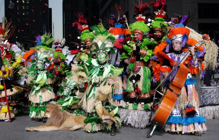 Photograph of a mummer band, dressed in full costume