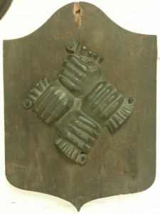 The symbol of the Philadelphia Contributionship consisted of four clasped hands, representing the community helping each other through loss by fire. This image appeared on fire marks placed on insurance holder's buildings, and still represents the company today. (Camden County Historical Society) 