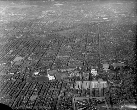 A black and white aerial photograph of North Philadelphia. About thirty city blocks are visible in the image, with many of the row houses blending together. 