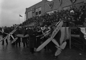 photograph of several people holding model airplanes