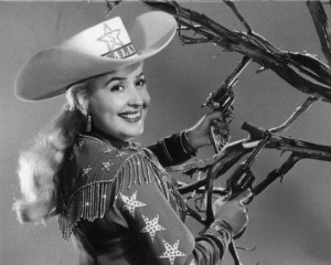 black and white photograph of Sally Starr in full cowgirl costume