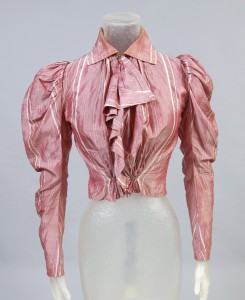 photograph of a dark rose shirtwaist blouse, displayed on a headless mannequin