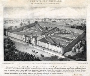 A newspaper clipping that shows an aerial sketch of eastern state penitentiary from 1856. Seven cellblocks radiate out from a central hub, and a thirty foot, castle-like wall surrounds the entire 10 acre site