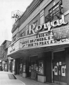 Photograph of the exterior of the Royal Theater, showing the marquee for the last show, as well as a for sale sign