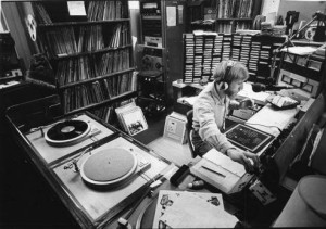 black and white photograph of a young man DJing a radio set