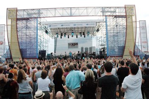 color photograph of a large crowd facing the stage as musicians perform during the XPoNential Festival