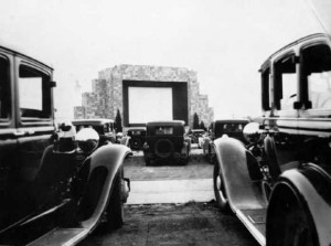 Owners and their automobiles partaking in a drive-in movie at the first drive-in movie theater.