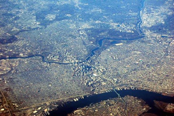 aerial photograph showing Center City Phila and environs, with the Delaware River near bottom of image and the Schuylkill River crussing across the middle, with Manayunk in upper right, West Philadelphia spreading from center to upper left, and south philadelphia in the lower left quadrant.