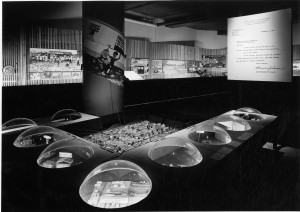 black and white photo showing a display at the Better Philadelphia Exhibition of 1947, with nine plexiglas domes rising from a table surface, lit from within to show building proposals. 