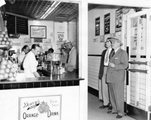 Black and white photograph of the inside of a Dewey's restaurant in the 1950s.