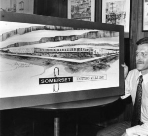 The president of the Somerset Knitting Mills is shown here looking over the architectural rendering of the new building in 1976