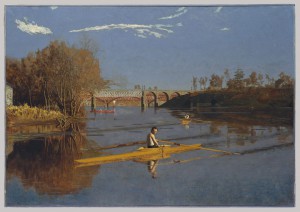 A landscape painting of a river, reflecting a close embankment to the left side and a more distant one on the right. Two bridges run parallel with the horizon line, and the main subject of the painting is Max Schmitt, seating in a single, yellow scull, turned to his right to look at the viewer. Another sculler is rowing away toward the bridges and horizon behind him.