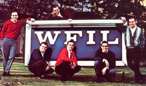 Color photograph depicting six of the Famous 56 "Boss Jocks" posed around a WFIL sign.