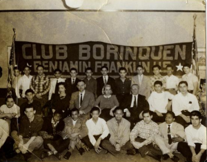 A black and white photograph of a group of students in front of a banner reading "Club Borinquen Benjamin Franklin HS"