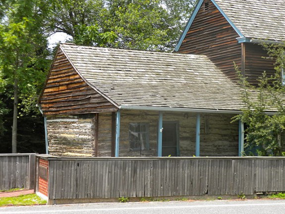 Color photograph of wooden structure with porch.