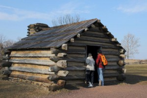 Color photograph of a log cabin or hut.