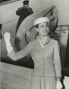 A black and white photograph of Grace Kelly waving