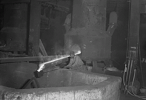 A Molder collecting liquefied steel at Baldwin Locomotives' Eddystone, Pa plant.