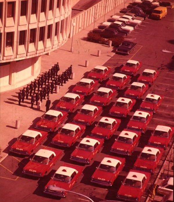 Aerial view of red Philadelphia Police Cars outside of the Police Administration Building.