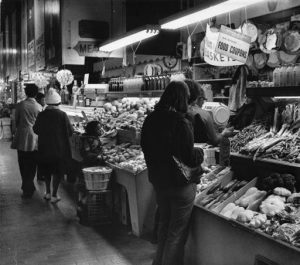 Customers browse the produce section of the Reading Terminal Market 