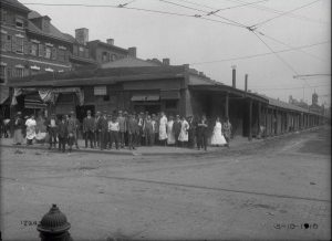 People standing outside of a restaurant and coffee house in 1916.