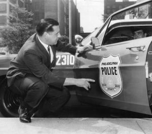 Police Commissioner Frank Rizzo Examining the New Police Insignia.