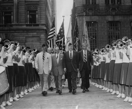 Leaders of the Veterans of Foreign Wars (VFW) walk through two lines of the Audubon All-Girl Drum and Bugle Corps at a ceremony at City Hall in Philadelphia in 1954.