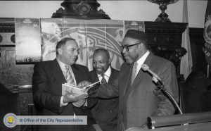 a black and white photograph of Mayor Ed Rendell shaking hands with Kenny Gamble and Leon Huff