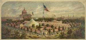 A color illustration of Logan Square during a fair. Two large tents and several temporary buildings are shown, and a very large American flag flies over the grounds. In the background, the Cathedral Basilica of Sts Peter and Paul dominates the horizon.