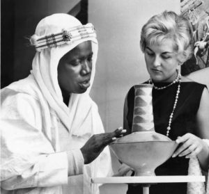 he Nigerian legislator Alhaji Umaru Gwandu, shown here at left, explains the significance of the decorations on a pottery jug from northern Rhodesia (now known as Zimbabwe).