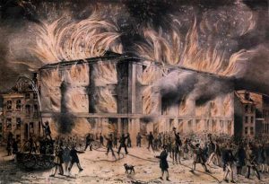 A color painting of a large building engulfed in flames with a cheering mob in the streets.