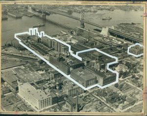 A black and white aerial image of the Camden waterfront with the former RCA-Victor buildings highlighted