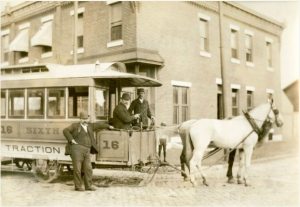 black and white photo of a horse drawn streetcar