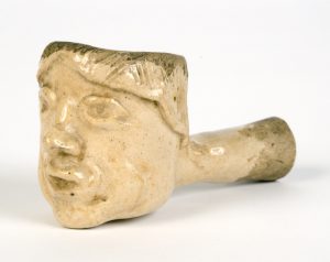 a color photograph of a pipe sculpted in the image of a man's face