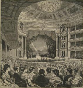 A black and white illustration of a large well-dressed audience watching a show at the Academy of Music