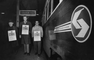 SEPTA employees striking next to a Red Arrow Line train 