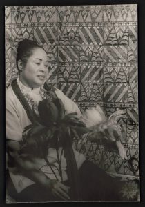 a black and white photograph of actress Juanita Hall portraying the character "Bloody Mary" from South Pacific