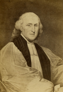 Portrait of Bishop William White. The image is from his waist up. He is seated, with his right arm crossing his body in the lower half of the fram. He is an older white man, bald on top of his head but with longer, curly white hair around the sides and back of his head. He wears a religous robe.