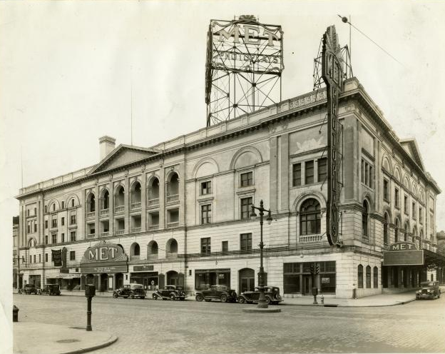 a black and white photograph of a large opera house with a billboard-style sign above reading The Met