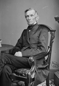 A black and white photographic portrait of Theodore Frelinghuysen. Frelinghuysen is seated in an appointed parlor looking into the camera.