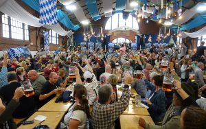 Color photo of Oktoberfest revelers inside Armory building, October 2016