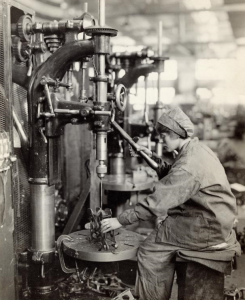 A Woman works to drill a metal filling within the aircraft factory of the Philadelphia Naval Yard